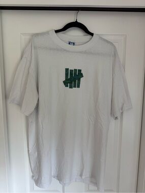 Undefeated White Short Sleeve Tee with Army Green Logo